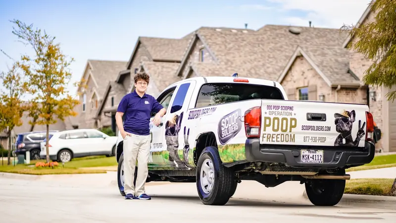Scoop Soldiers owner beside a branded truck